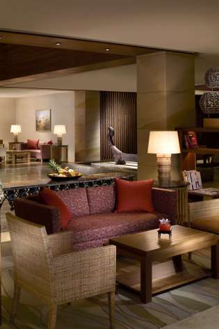 Hotel lobby with sofas and chairs .