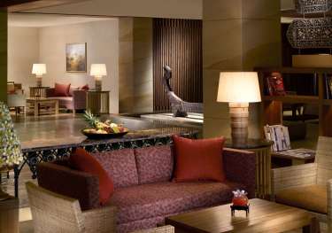 Hotel lobby with sofas and chairs .