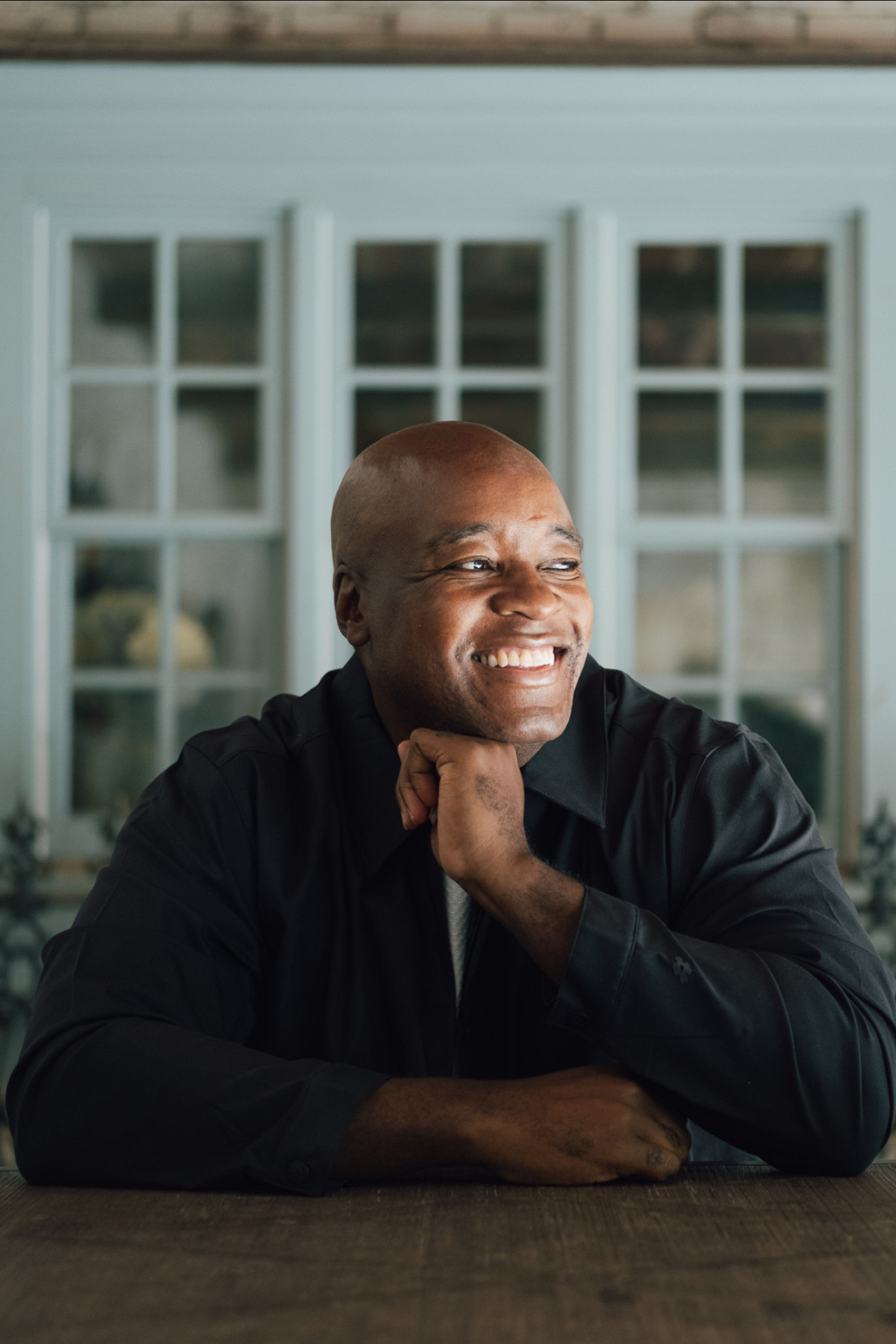 headshot of ronald ndoro mind sat at table