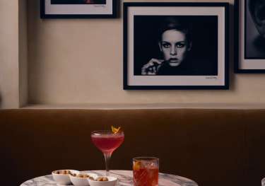 Negroni cocktails on a round marble table at Rosina.