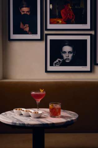 Negroni cocktails on a round marble table at Rosina.