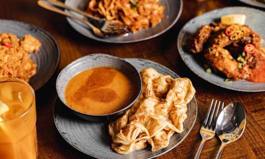 Spread of food on table from Roti King restaurant .