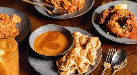Spread of food on table from Roti King restaurant .