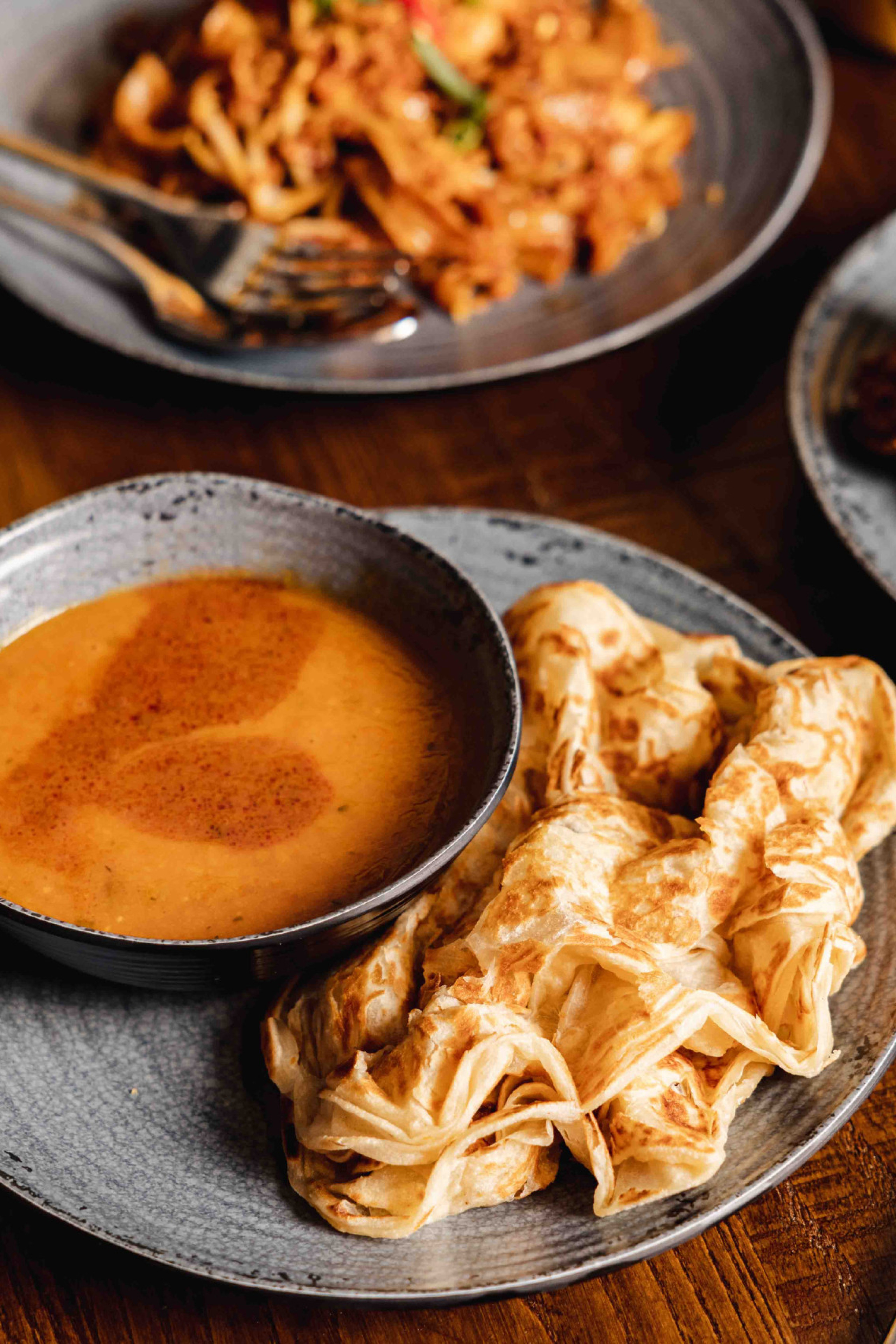 spread of food on table from Roti King restaurant 
