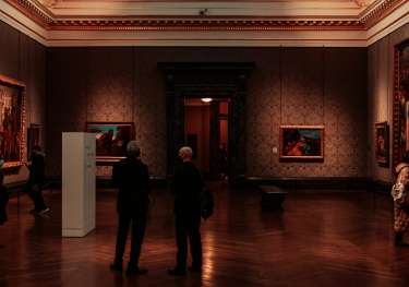 Dark art gallery room with windows on the ceiling.