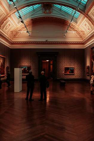 Dark art gallery room with windows on the ceiling.