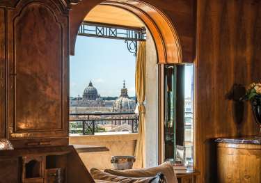 Hotel suite in Rome with city skyline view.
