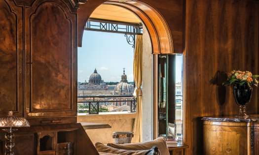 Hotel suite in Rome with city skyline view.