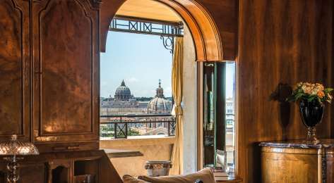 Hotel suite in Rome with city skyline view.