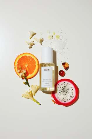 Ouai hair mist surrounded by slices of orange and dragon fruit.