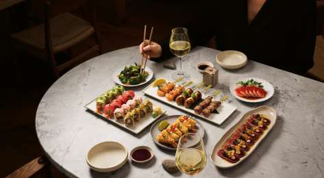 Sushi dishes at sticks'n'sushi restaurant .