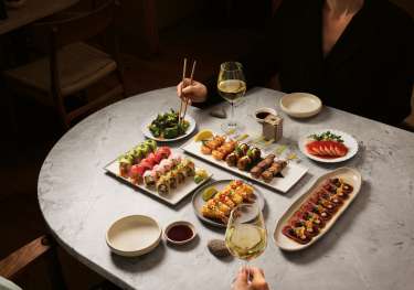 Sushi dishes at sticks'n'sushi restaurant .