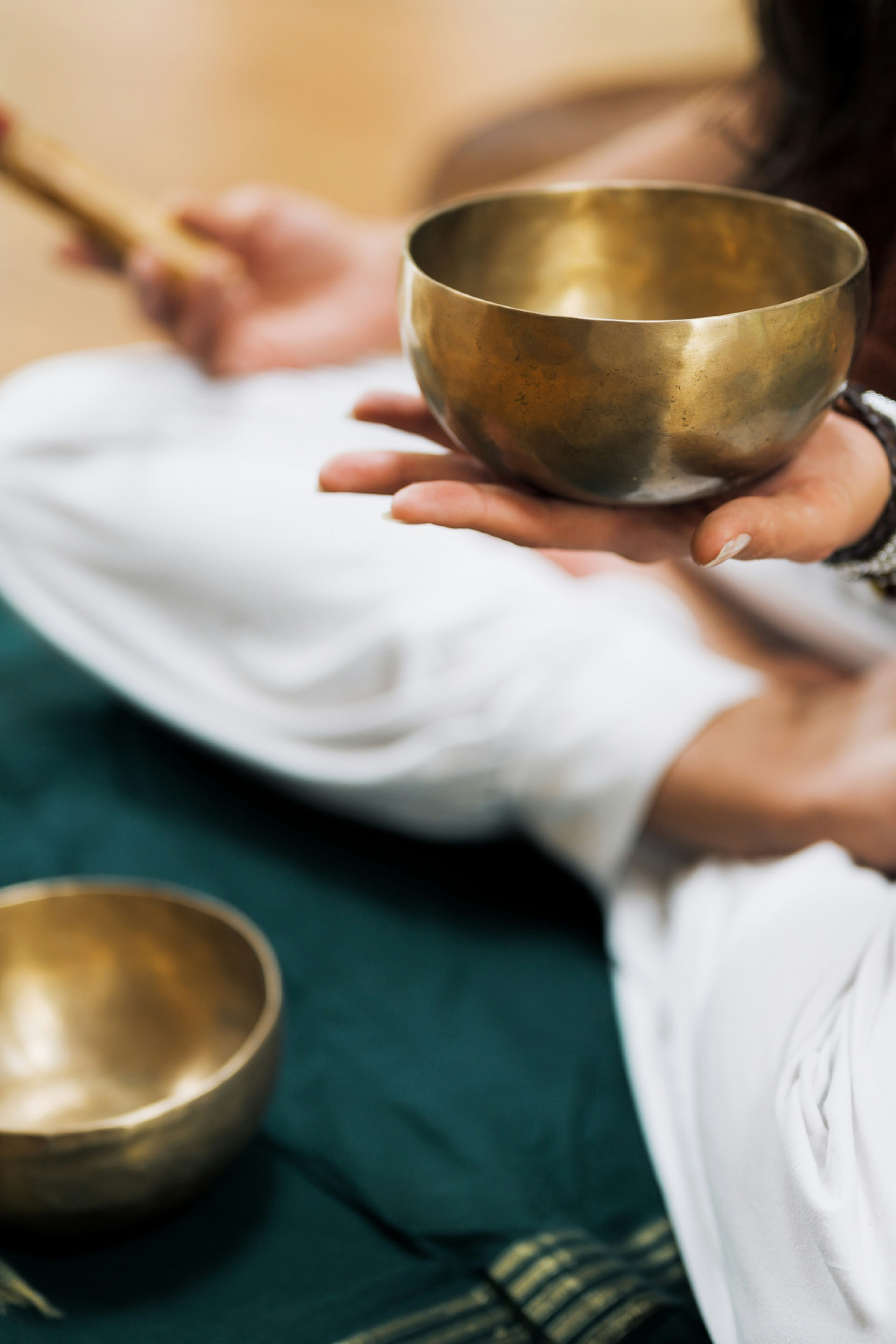 person using metal singing bowl 