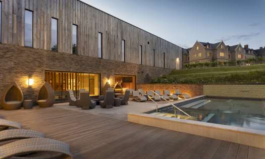 Photo of hotel outdoor pool at dusk .