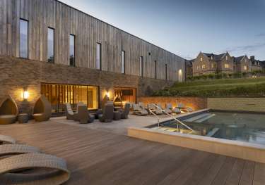 Photo of hotel outdoor pool at dusk .
