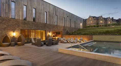 Photo of hotel outdoor pool at dusk .