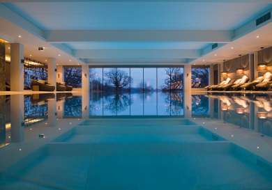Photo of luxurious indoor pool with views outside .