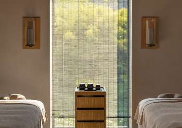 Hotel spa treatment room with twin beds .