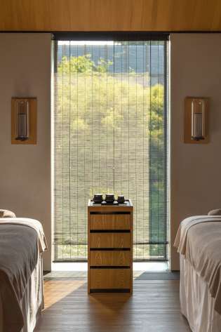 Hotel spa treatment room with twin beds .