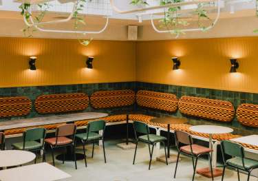Restaurant with green and orange interior .