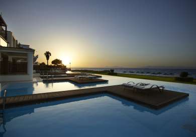 View of rhodes hotel swimming pool at sunset.