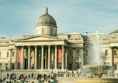 London National Gallery big white building with fountain in front.