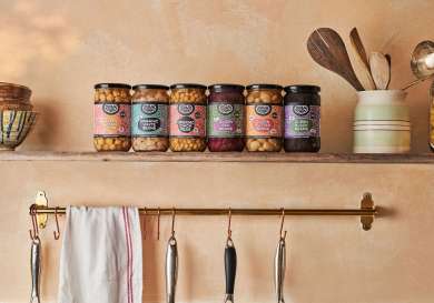 Jars of beans on shelf in kitchen.