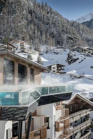 Hotel in austria surrounded by chalets .