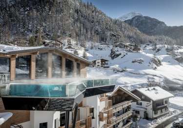 Hotel in austria surrounded by chalets .