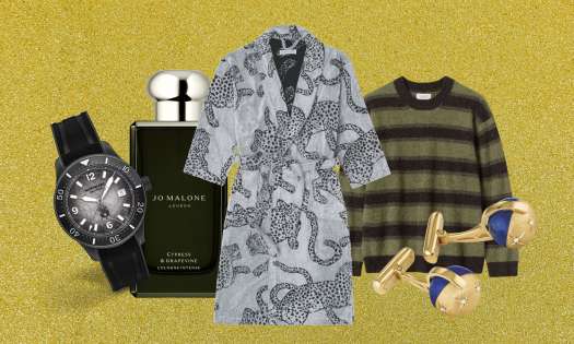 Array of men's gifts on gold glitter background.