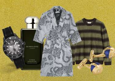 Array of men's gifts on gold glitter background.