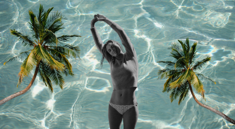 Model posing in bikini with palm trees and pool background.