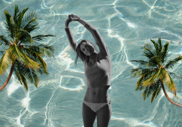 Model posing in bikini with palm trees and pool background.