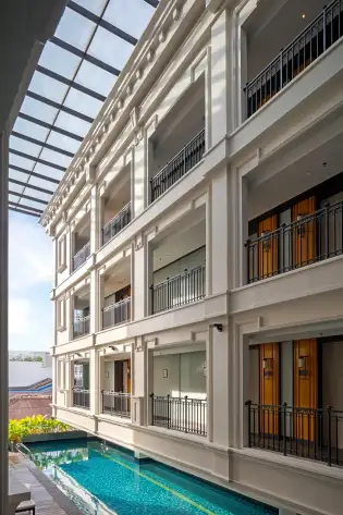 Outdoor swimming pool at the george penang hotel .