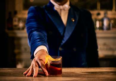 Barman serving a negroni at the landmark's mirror bar .