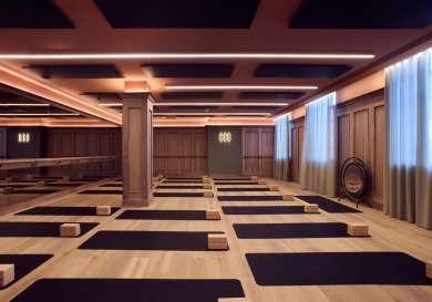 Fitness studio at third space chelsea with black yoga mats.
