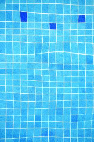 Aerial view of blue swimming pool tiles.