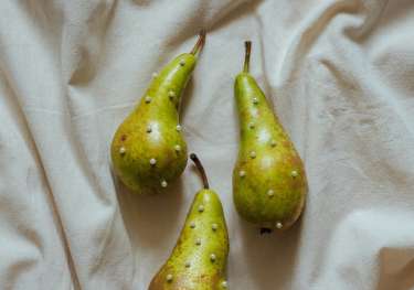 Three pears studded with small pearls.