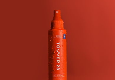 Facial spray on red background.