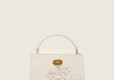 Cream handbag with flowers.