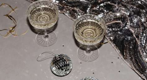Two glasses of fizz with silver stars and tiny mirror balls.