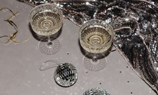 Two glasses of fizz with silver stars and tiny mirror balls.