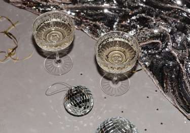 Two glasses of fizz with silver stars and tiny mirror balls.