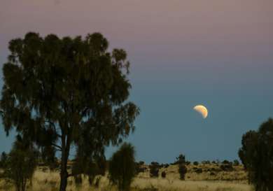 Uluru national park at night with the moon.