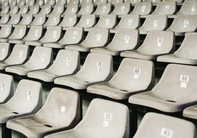 Grey seats in football stadium.