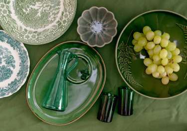 Vintage homeware on green tablecloth.
