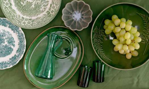 Vintage homeware on green tablecloth.
