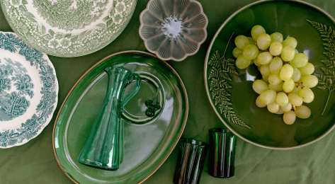 Vintage homeware on green tablecloth.