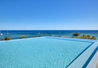 Hotel swimming pool with views across the sea in Ibiza.