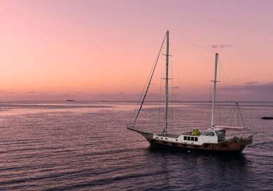 Yacht at sea during sunset in the maldives.